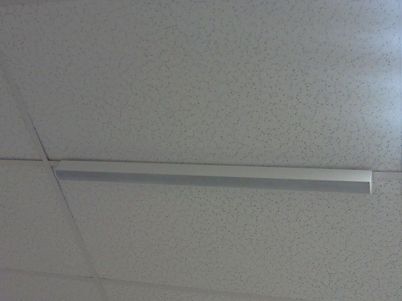 Close-up: the PHA-25 mounted flush along the ceiling T-bar